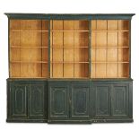 A GEORGE III INDIGO GREEN PAINTED PINE BREAKFRONT BOOKCASE, EARLY 19TH CENTURY
