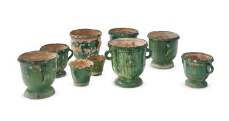 A GROUP OF NINE WEATHERED GREEN GLAZED POTTERY JARDINIERES, EARLY 20TH CENTURY AND LATER