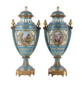 A PAIR OF FRENCH PORCELAIN AND GILT METAL MOUNTED SEVRES STYLE 'JEWELLED' TURQUOISE GROUND URNS AND