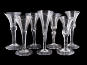 SEVEN VARIOUS PLAIN-STEMMED WINE GLASSES MID 18th CENTURY AND LATERFor the most part Low Countries