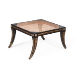 AN EBONISED HARDWOOD AND PARCEL GILT STOOL IN REGENCY STYLE