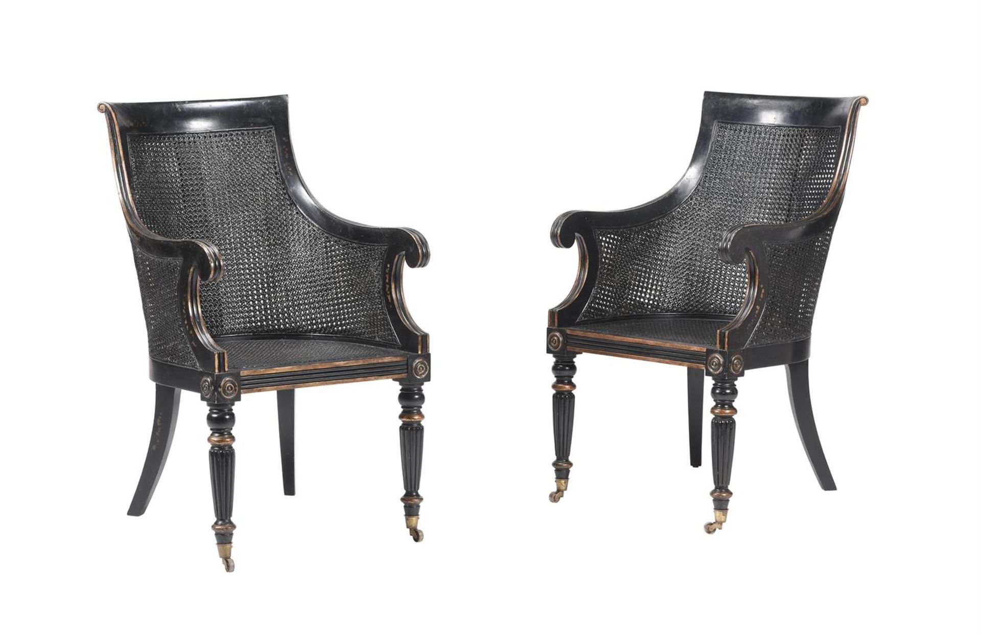 A PAIR OF EBONSIED BERGERE AMRCHAIRS IN GEORGE IV STYLE