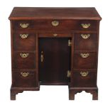 A GEORGE II MAHOGANY KNEEHOLE DESK