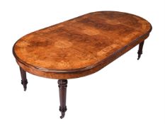 A WALNUT AND INLAID EXTENDING DINING TABLE IN VICTORIAN STYLE