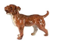 A FRENCH RED POTTERY MODEL OF A DOG, ATTRIBUTED TO POTERIE DU MESNIL DE BAVENT