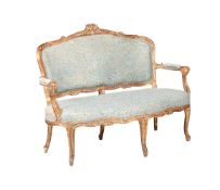 A CONTINENTAL CARVED GILTWOOD FRAMED SETTEE