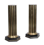 A PAIR OF EBONISED AND GILT METAL MOUNTED PEDESTAL COLUMNS