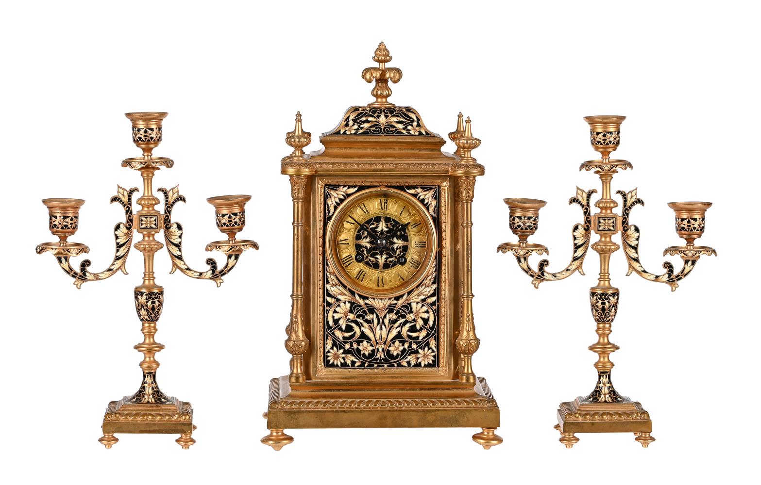 A FRENCH GILT BRASS AND CHAMPLEVE ENAMEL MANTEL CLOCK GARNITURE