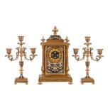 A FRENCH GILT BRASS AND CHAMPLEVE ENAMEL MANTEL CLOCK GARNITURE
