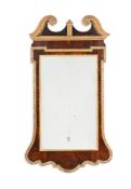 A GEORGE II WALNUT AND PARCEL GILT MIRROR
