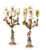 A PAIR OF GILT METAL AND PORCELAIN INSET FIVE LIGHT CANDELABRA