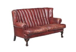 A LEATHER UPHOLSTERED SETTEE, IN GEORGE II STYLE