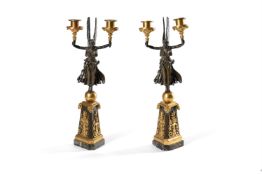 A PAIR OF FRENCH BRONZE AND GILT FIGURAL CANDELABRA IN EMPIRE STYLE