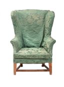 A GEORGE III ASH AND GREEN DAMASK UPHOLSTERED WING ARMCHAIR