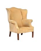 A MAHOGANY AND UPHOLSTERED WING ARMCHAIR IN GEORGE III STYLE