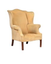 A MAHOGANY AND UPHOLSTERED WING ARMCHAIR IN GEORGE III STYLE