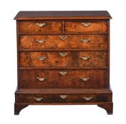 A WALNUT, ASH AND CROSSBANDED CHEST ON STAND