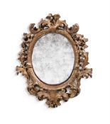 A SMALL ITALIAN CARVED GILTWOOD OVAL MIRROR, SECOND HALF 18TH CENTURY