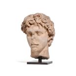 A ROMAN WHITE MARBLE PORTRAIT HEAD OF A YOUNG MAN, 2ND CENTURY A.D.