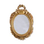 A LOUIS XV CARVED GILTWOOD OVAL MIRROR, CIRCA 1770