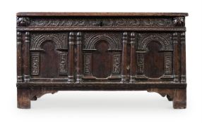 A CHARLES I PANELLED OAK CHEST OR COFFER, CIRCA 1630