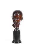 AUGUSTINE RIGANELLI (1890-1949) A CARVED WOOD HEAD OF A YOUNG BOY, EARLY 20TH CENTURY