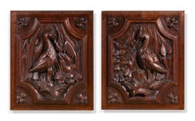 A PAIR OF CARVED OAK PANELS DEPICTING HERONS, CIRCA 1850-1880