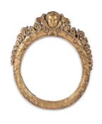 A CARVED GILTWOOD OVAL MIRROR FRAME, 18TH CENTURY