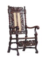 A RARE CHARLES II WALNUT RECLINING ARMCHAIR, CIRCA 1660