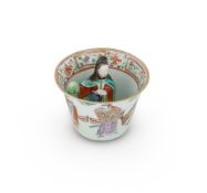 A Chinese Famille Rose figural 'trick' cup
