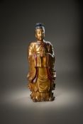A large and impressive Chinese gilt lacquer figure of a patron