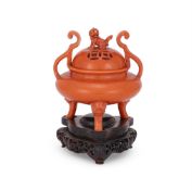 A Chinese Dehua iron-red glazed tripod censer