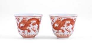 A pair of Chinese iron red 'Dragon' wine cups