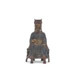 A Chinese bronze model of a seated scholar