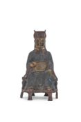 A Chinese bronze model of a seated scholar