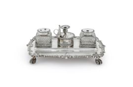 A GEORGE III SILVER SHAPED OBLONG INKSTAND