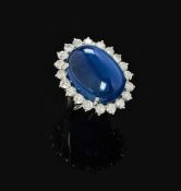 A DIAMOND AND CABOCHON SAPPHIRE CLUSTER RING