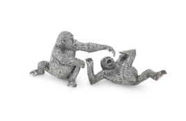 A PAIR OF AFRICAN SILVER MODELS OF ADOLESCENT GORILLAS AT PLAY