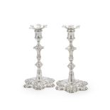 A PAIR OF GEORGE II CAST SILVER CANDLESTICKS