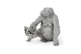 AN AFRICAN SILVER MODEL OF A GORILLA MOTHER AND HER BABY