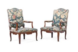 A PAIR OF EARLY LOUIS XV WALNUT AND TAPESTRY UPHOLSTERED FAUTEUILS, CIRCA 1730