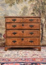A GEORGE I BURR ASH AND ELM CROSSBANDED CHEST OF DRAWERS, CIRCA 1720