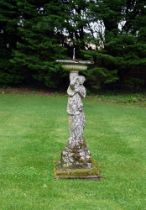 A STONE COMPOSITION SUNDIAL IN THE FORM OF A MAIDEN, 20TH CENTURY