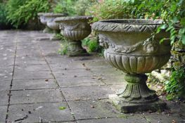 A SET OF FOUR STONE COMPOSITION URNS, IN 19TH CENTURY STYLE, 20TH CENTURY