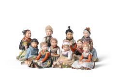 A SET OF TEN ROYAL COPENHAGEN PORCELAIN FIGURES OF DANISH CHILDREN IN REGIONAL COSTUME