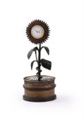 A FRENCH GILT AND PATINATED BRONZE SUNFLOWER TIMEPIECE WITH INKSTAND, EARLY 19TH CENTURY