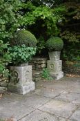 A PAIR OF STONE COMPOSITION PLANTERS ON PLINTHS, LATE 20TH CENTURY