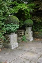 A PAIR OF STONE COMPOSITION PLANTERS ON PLINTHS, LATE 20TH CENTURY