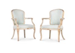 A PAIR OF GEORGE III CREAM PAINTED AND PARCEL GILT OPEN ARMCHAIRS, CIRCA 1780
