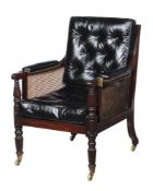 A REGENCY MAHOGANY AND LEATHER UPHOLSTERED BERGERE LIBRARY ARMCHAIR, CIRCA 1815